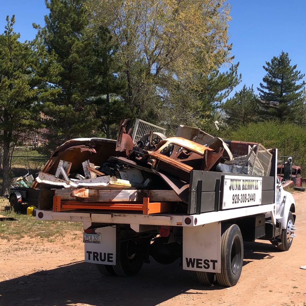 True West truck hauling scrap metal and old car panels
