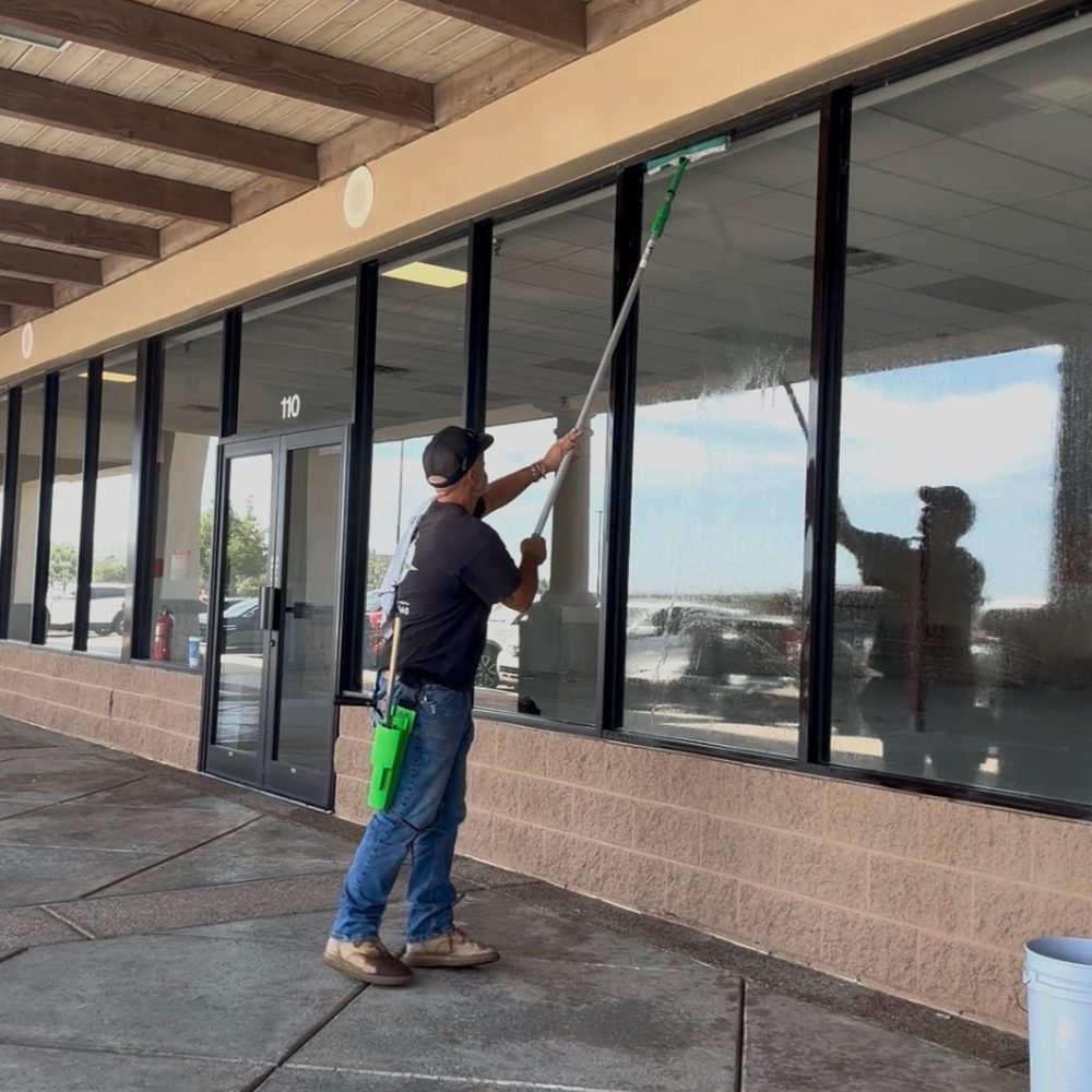 True West crew member cleaning storefront windows in Arizona