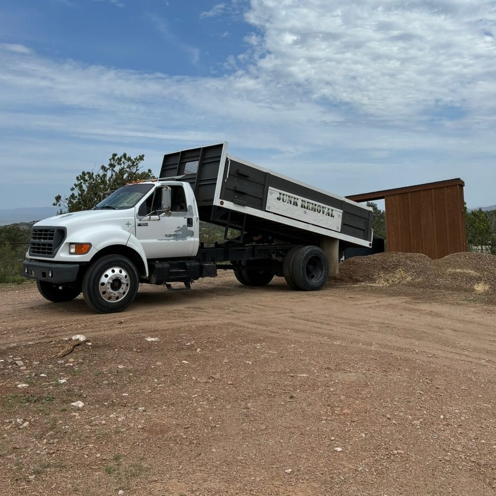 True West dump truck unloading landscape material