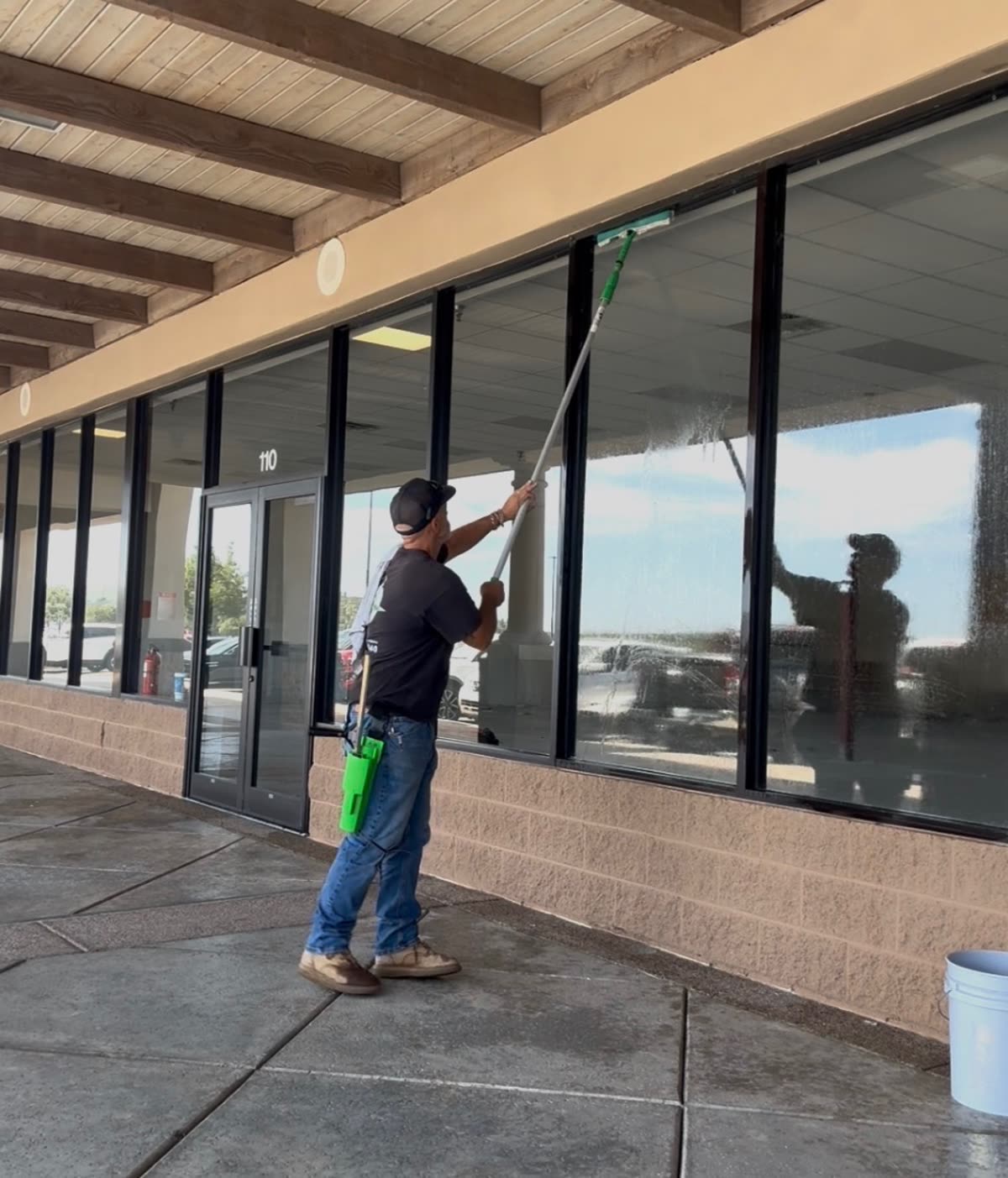 True West technician squeegeeing large storefront windows